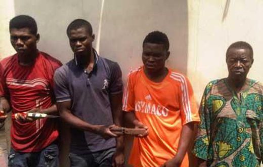 Najim Bakare (right) with other suspects.