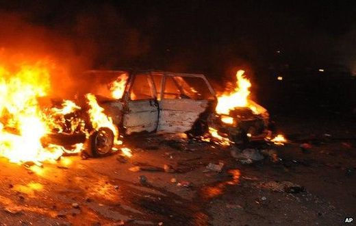Car burns following a bomb blast in Abuja on 1 May 2014