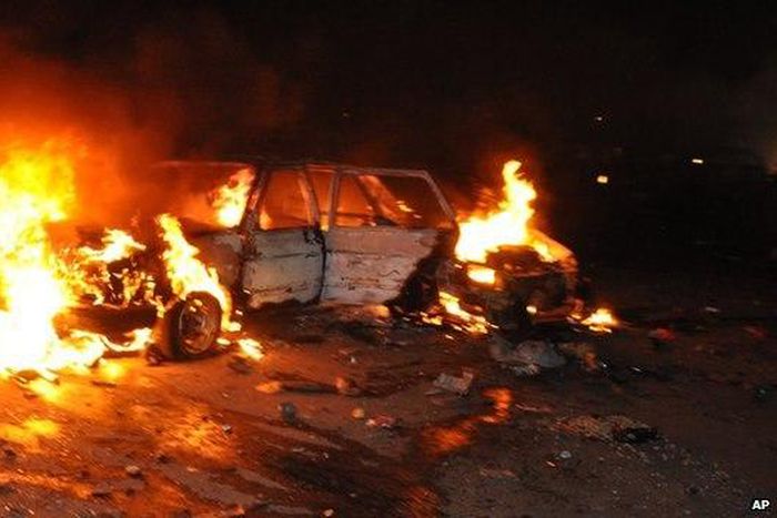 Car burns following a bomb blast in Abuja on 1 May 2014