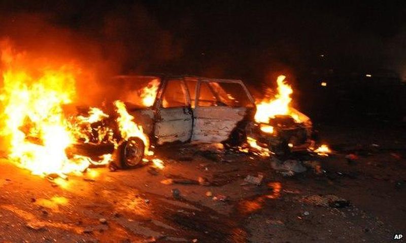 Car burns following a bomb blast in Abuja on 1 May 2014