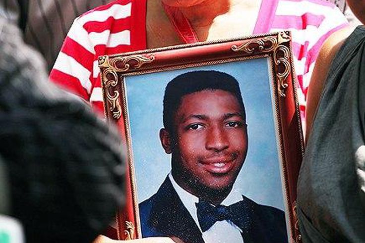 Gwen Carr holding a photo of her late son, Eric Garner