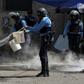 Police try to put out tires set ablaze in a Honduras opposition demonstration on January 27, 2019