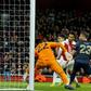 Arsenal's Gabonese striker Pierre-Emerick Aubameyang (2nd L) watches as his shot hits the empty net for Arsenal's first goal during the English FA Cup fourth round football match between Arsenal and Manchester United at the Emirates Stadium in London o...