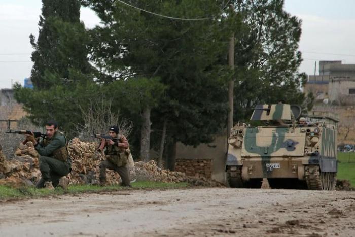 Turkish-backed Syrian rebels participate in a training exercise using an armoured vehicle provided by the Turkish army near Tal Hajar in Aleppo's province, a few kilometres from areas controlled by a Kurdish-led coalition