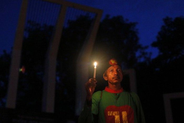 A Bangladeshi activist holds a candle, as they protest against the killing of secular blogger Niloy Chakrabarti in Dhaka, Bangladesh.