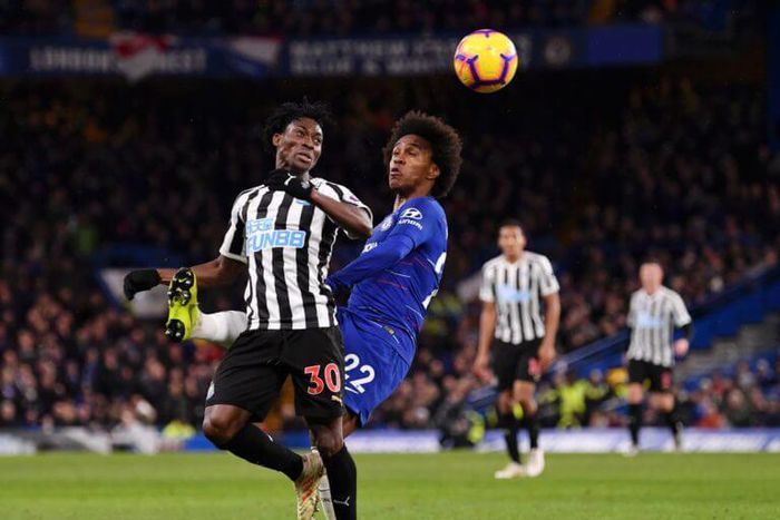 Christian Atsu fights for the ball with Chelsea's Willian