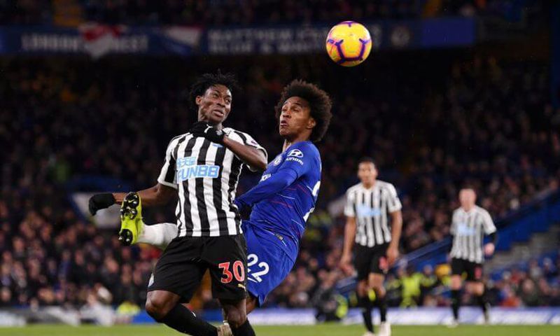 Christian Atsu fights for the ball with Chelsea's Willian