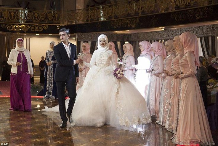 Chechen newlyweds, Zara Khasanova and her groom, prepare to dance during a wedding ceremony in Grozny. Chechen weddings are traditionally paid for by the groom and attended by his family members