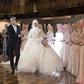 Chechen newlyweds, Zara Khasanova and her groom, prepare to dance during a wedding ceremony in Grozny. Chechen weddings are traditionally paid for by the groom and attended by his family members