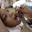 A health worker gives a child an oral polio vaccine in Kano, Nigeria.