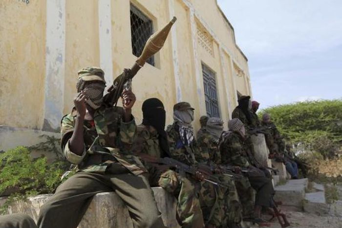 Al Shabaab soldiers sit outside a building during patrol along the streets of Dayniile district in Southern Mogadishu, March 5, 2012. Photo Credit: Reuters