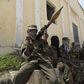 Al Shabaab soldiers sit outside a building during patrol along the streets of Dayniile district in Southern Mogadishu, March 5, 2012. Photo Credit: Reuters