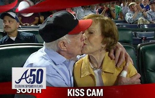 Former President Jimmy Carter kisses his wife Rosalynn on the “Kiss Cam” during a baseball game between the Atlanta Braves and the Toronto Blue Jays on Sept. 17, 2015