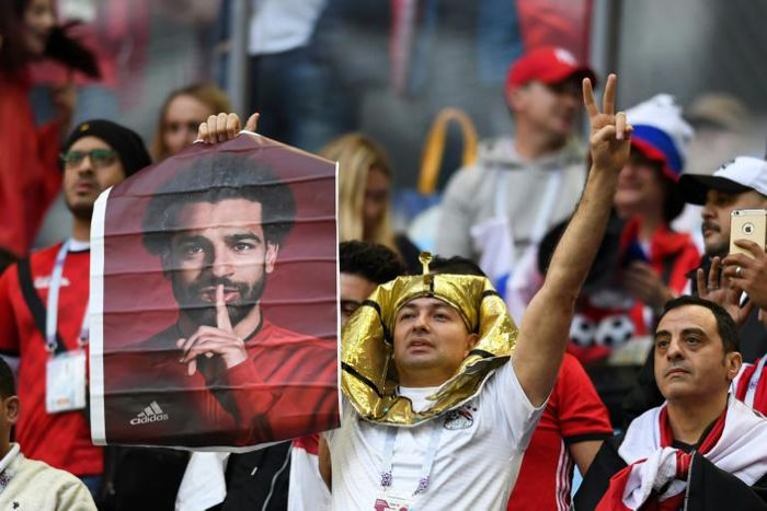 A fan holds a poster of Egypt forward Mohamed Salah ahead of a match against Russia at the World Cup on June 19, 2018