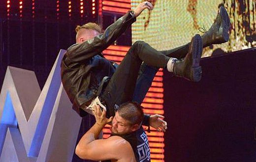 Machine Gun Kelly powerbombed off stage by Kevin Owens