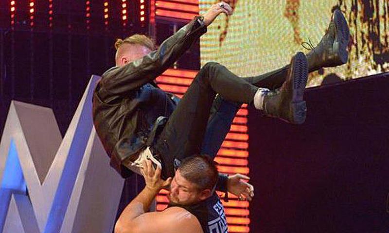 Machine Gun Kelly powerbombed off stage by Kevin Owens