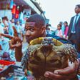 Usher Raymond displaying a turtle at a Moroccan market