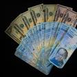 The US is sanctioning seven Venezuelans for allegedly plundering billions of dollars via black-market currency exchanges -- dollars and Venezuela bolivars are seen here