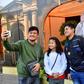 Worshippers pose for a selfie with a cutout image of Pope Francis at St Mary's Catholic Church in Dubai on January 30, 2019, days ahead of his visit to the United Arab Emirates