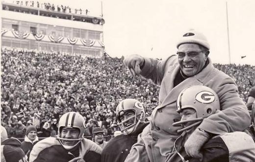 Coach Vince Lomardi being carried by his Green Bay Packers players after winning an NFL championship