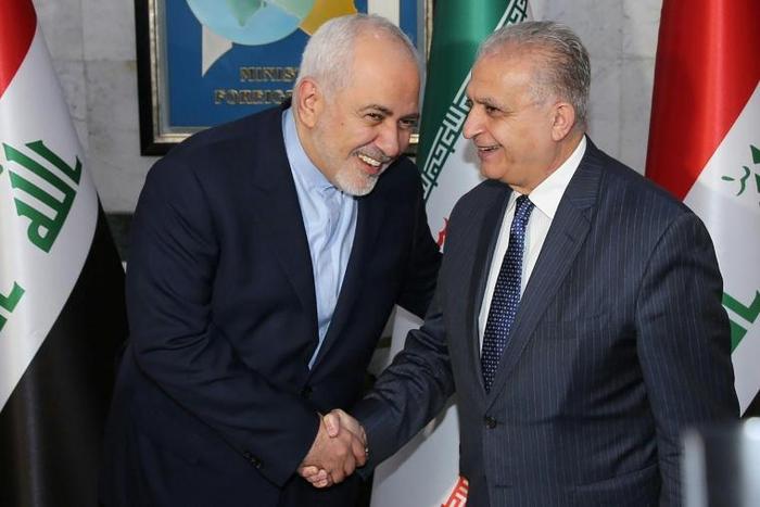 Iraqi Foreign Minister Mohammad Ali al-Hakim (R) receives his Iranian counterpart, Mohammad Javad Zarif, in Baghdad on January 13, 2019