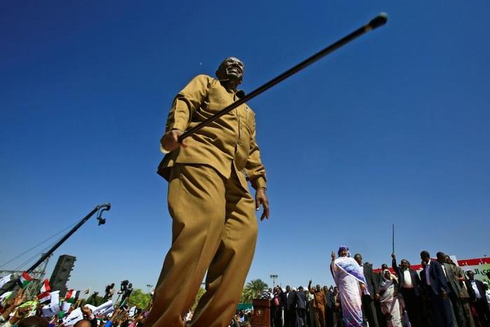 Sudanese President Omar al-Bashir brandishes his trademark cane at a loyalist rally in the capital Khartoum on January 9, 2019