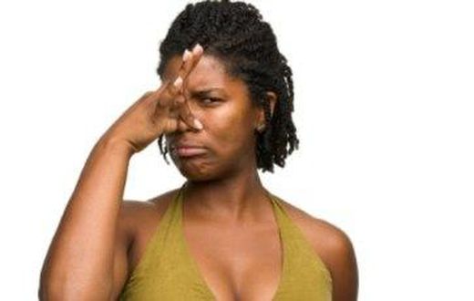 African woman covering her nose.