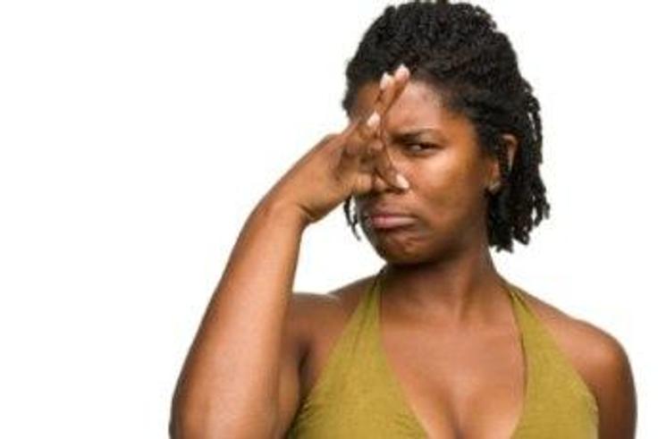 African woman covering her nose.