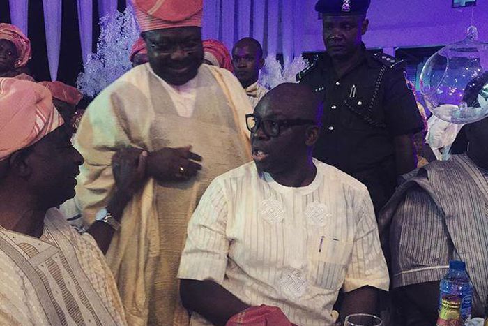 Senator Iyiola Omisore and Governor Fayose enjoy a quick chat while guests watched on