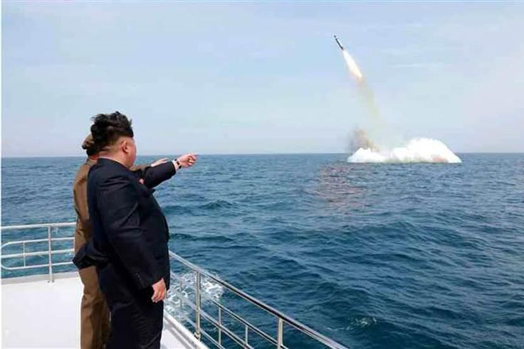 An image obtained by Yonhap News Agency shows North Korean leader Kim Jong Un pointing at a ballistic missile believed to have been launched from underwater on Saturday. 