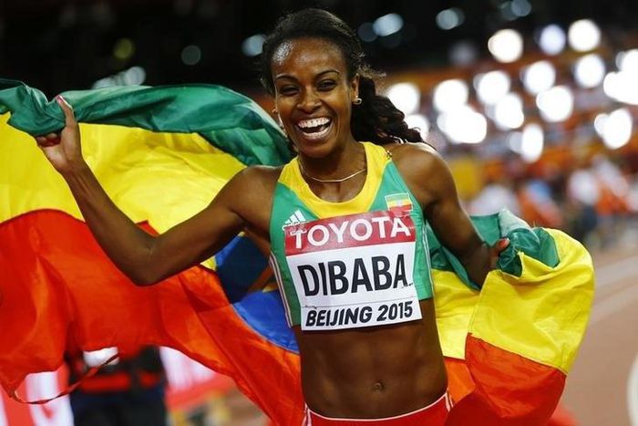 Genzebe Dibaba of Ethiopia holds her national flag after winning the women's 1500 metres final at the 15th IAAF World Championships at the National Stadium in Beijing, China August 25, 2015.     REUTERS/Kai Pfaffenbach