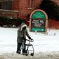 A person with a walker crosses Canfield Avenue in Detroit, Michigan