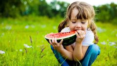 Little girl eating a watermelon