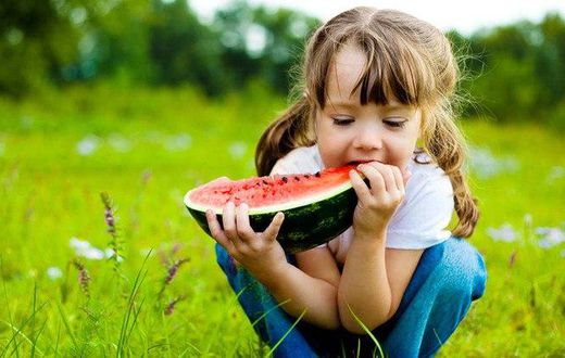 Little girl eating a watermelon