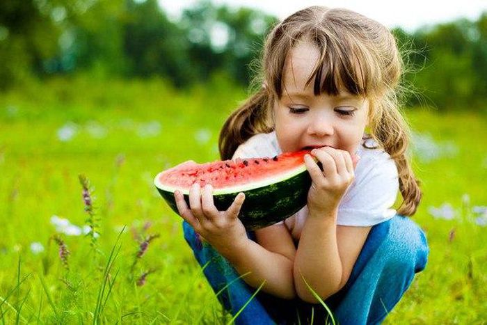 Little girl eating a watermelon