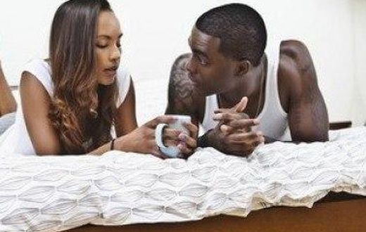 Couple talking in bed