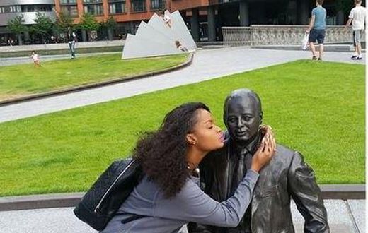 Dillish Matthews kissing a statue