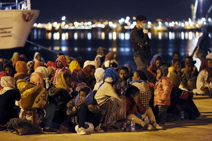Migrants rest after disembarking from the expedition vessel Phoenix in the Sicilian harbour of Augusta, Italy, June 7, 2015. REUTERS/Antonio Parrinello