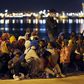 Migrants rest after disembarking from the expedition vessel Phoenix in the Sicilian harbour of Augusta, Italy, June 7, 2015. REUTERS/Antonio Parrinello