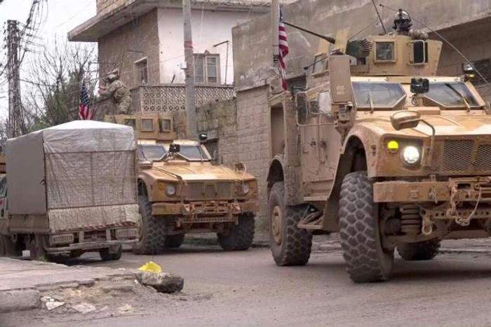 US armored vehicles at the scene of a suicide attack in the northern Syrian town of Manbij, where a suicide bomber killed 19 people including four Americans on January 16, 2019