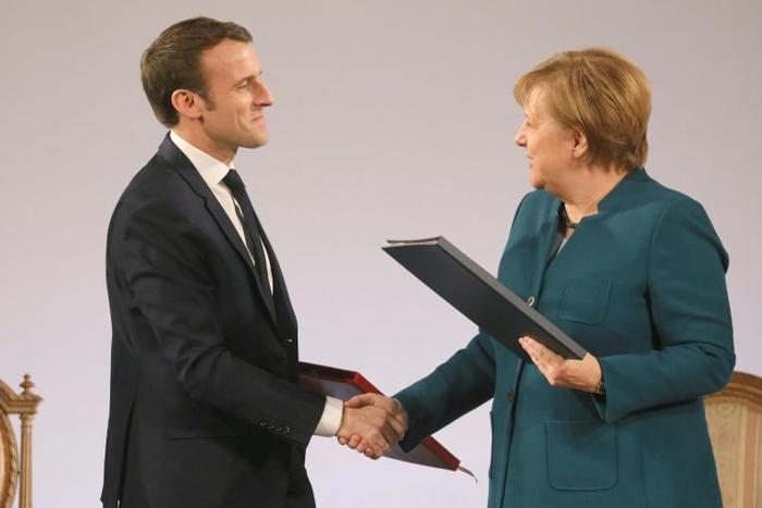 European news media associations wrote to French President Emmanuel Macron (L, pictured January 22, 2019) and German Chancellor Angela Merkel, saying a failure to reach an agreement would "jeopardise the whole EU copyright reform"