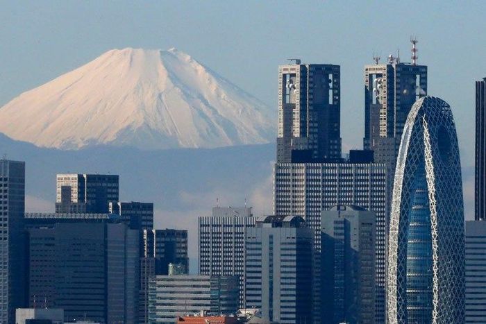 Japan's Mount Fuji behind Tokyo's skyscrapers.