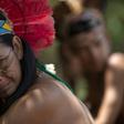 An indigenous woman of the Pataxo Ha-ha-hae community crying as she looks out over the Paraopeba river, filled with mud after a disastrous dam collapse in Brazil's Minas Gerais state