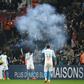 Marseille players Jordan Amavi, Kevin Strootman and Kostas Mitroglou react after a firecracker explodes beside the pitch during their team's defeat against Lille on Friday