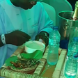 Nigerian man eating soaked gari at a party