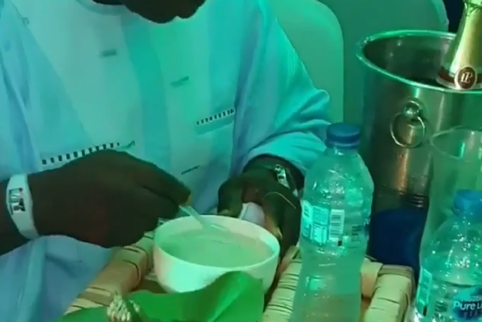 Nigerian man eating soaked gari at a party