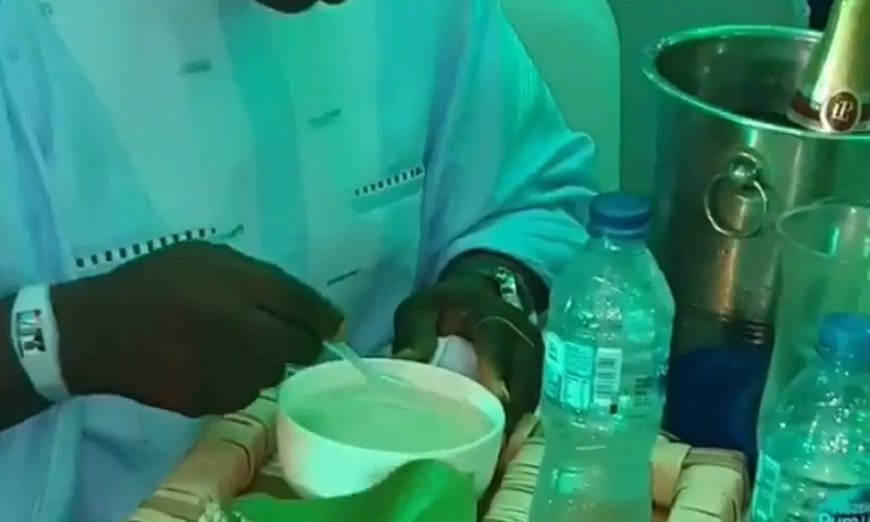 Nigerian man eating soaked gari at a party