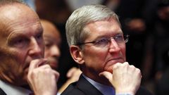 Apple CEO Tim Cook listening to a Barack Obama speech