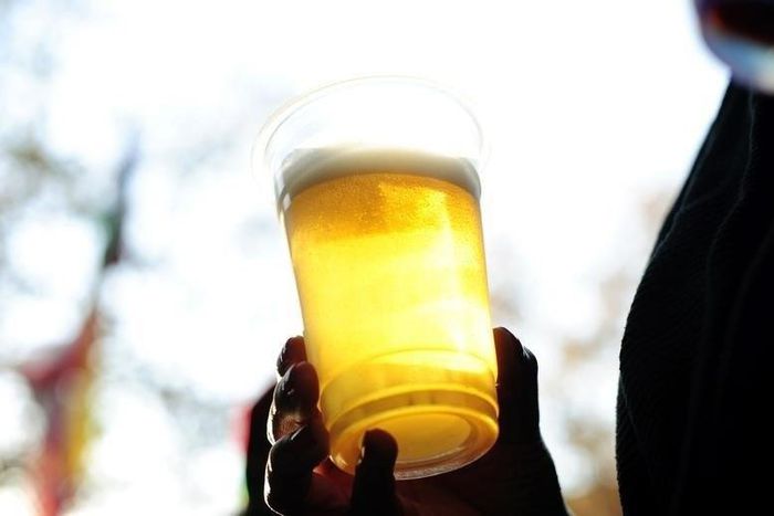 South African fans enjoy lager as they watch a large television screen at a bar in Pretoria, showing the final minutes of their team's 2010 World Cup soccer match against Mexico June 11, 2010.    REUTERS/Dylan Martinez