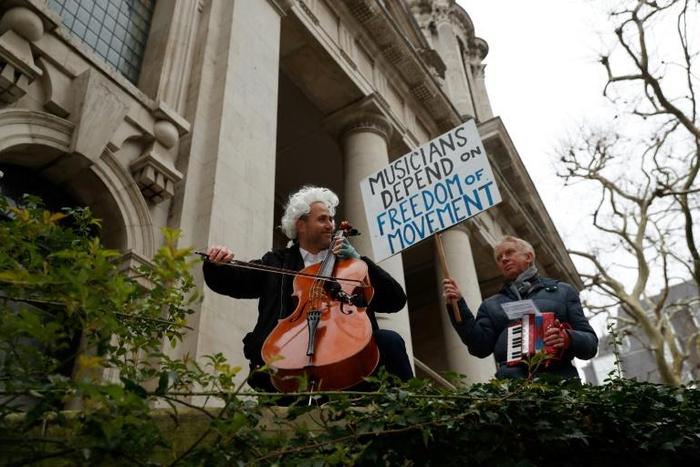 The family of British-German musician Simon Wallfisch, seen on the cello during a London performance to protest Brexit, were persecuted by the Nazis, but along with hundreds of others he is taking a German passport "to shore up some security for my fut...